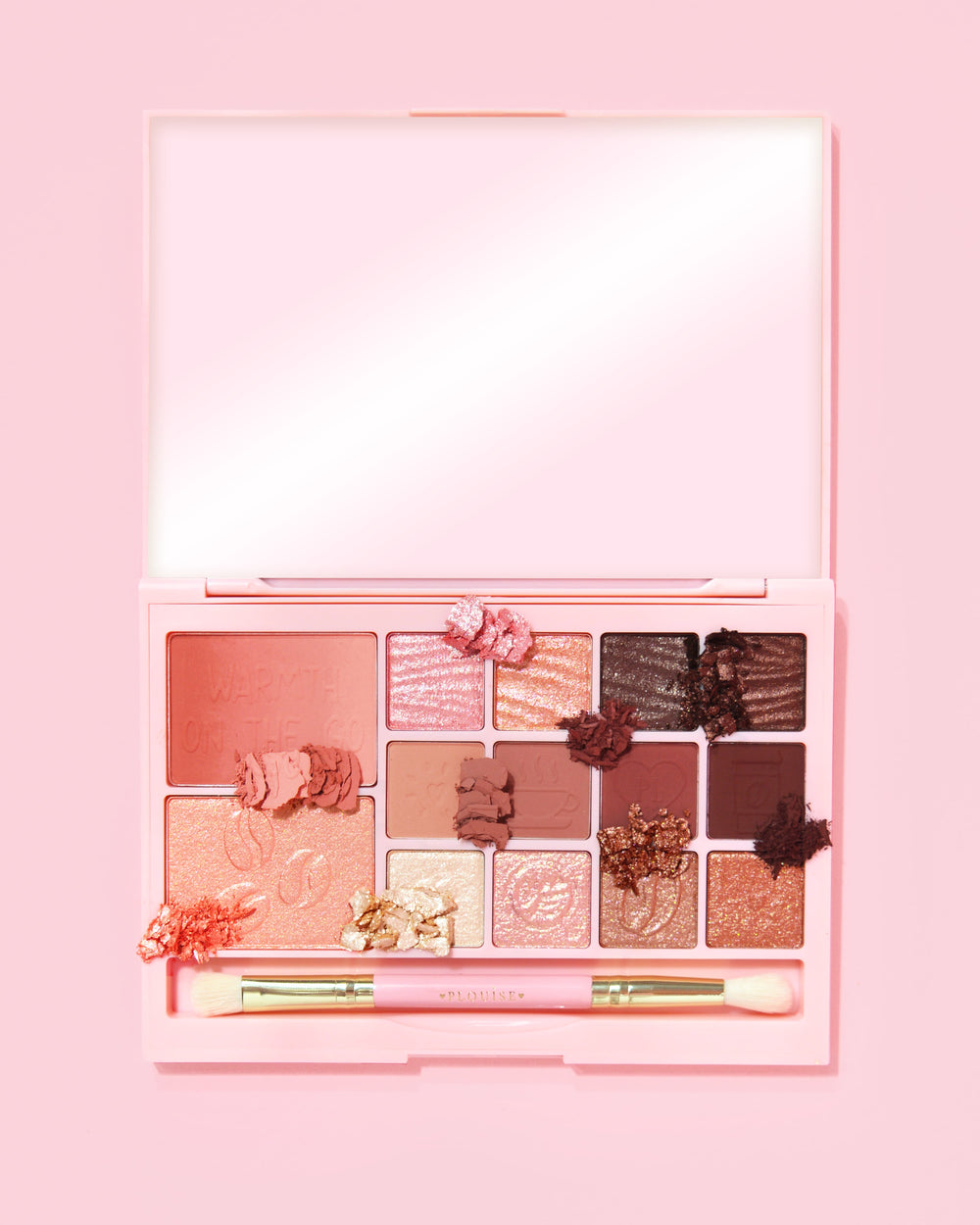 En bild på P. Louise Breakfast Bites All In One Makeup Palette i Hot To Go i neutrala och lila färger på en rosa bakgrund