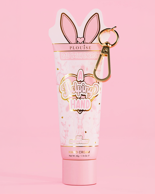 Pink P.Louise A Helping Hand Hand cream in pink marshmallow scent with bunny ears keychain on a pink background