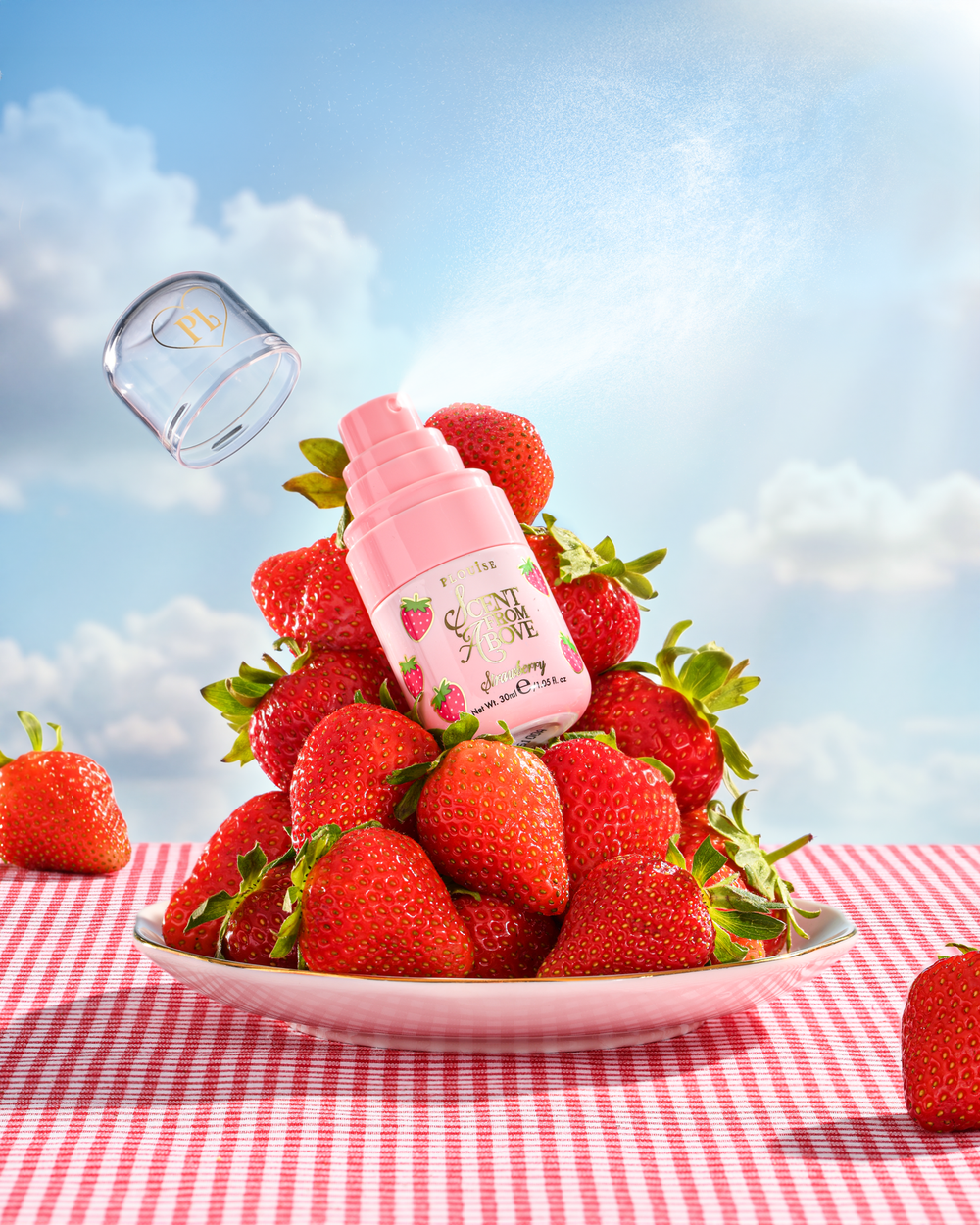 P.Louise Scent From Above Strawberry Hair & Body Mist on a plate with strawberries