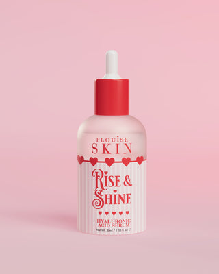 A bottle of P.Louise Rise and Shine Hyaluronic Acid Serum with a pink label and a red dropper, set against a pink background.