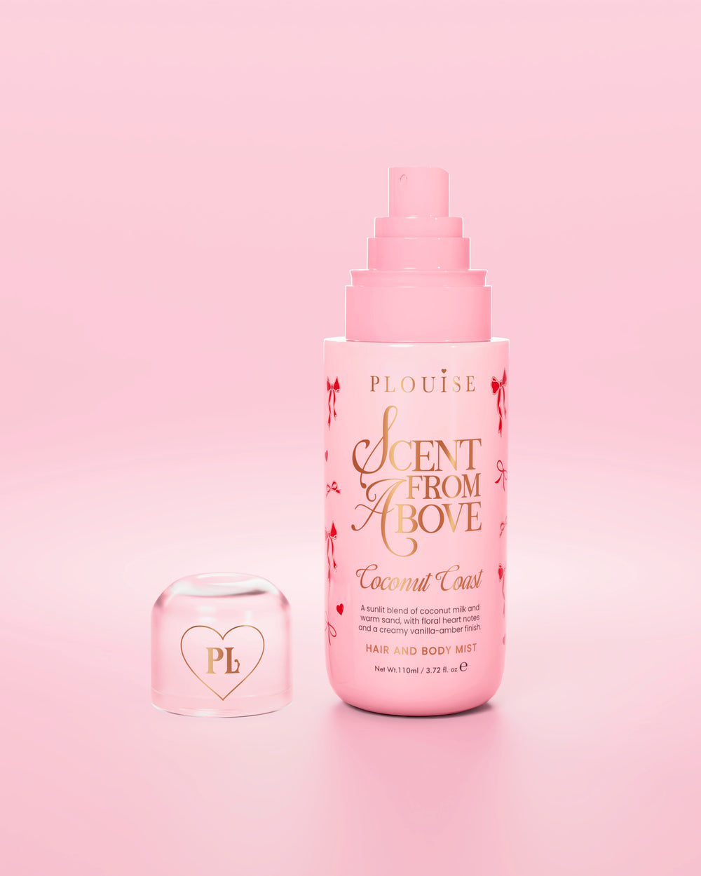 Pink bottle of 'Scent from Above' hair and body mist with red bow designs on the bottle and the cap off
