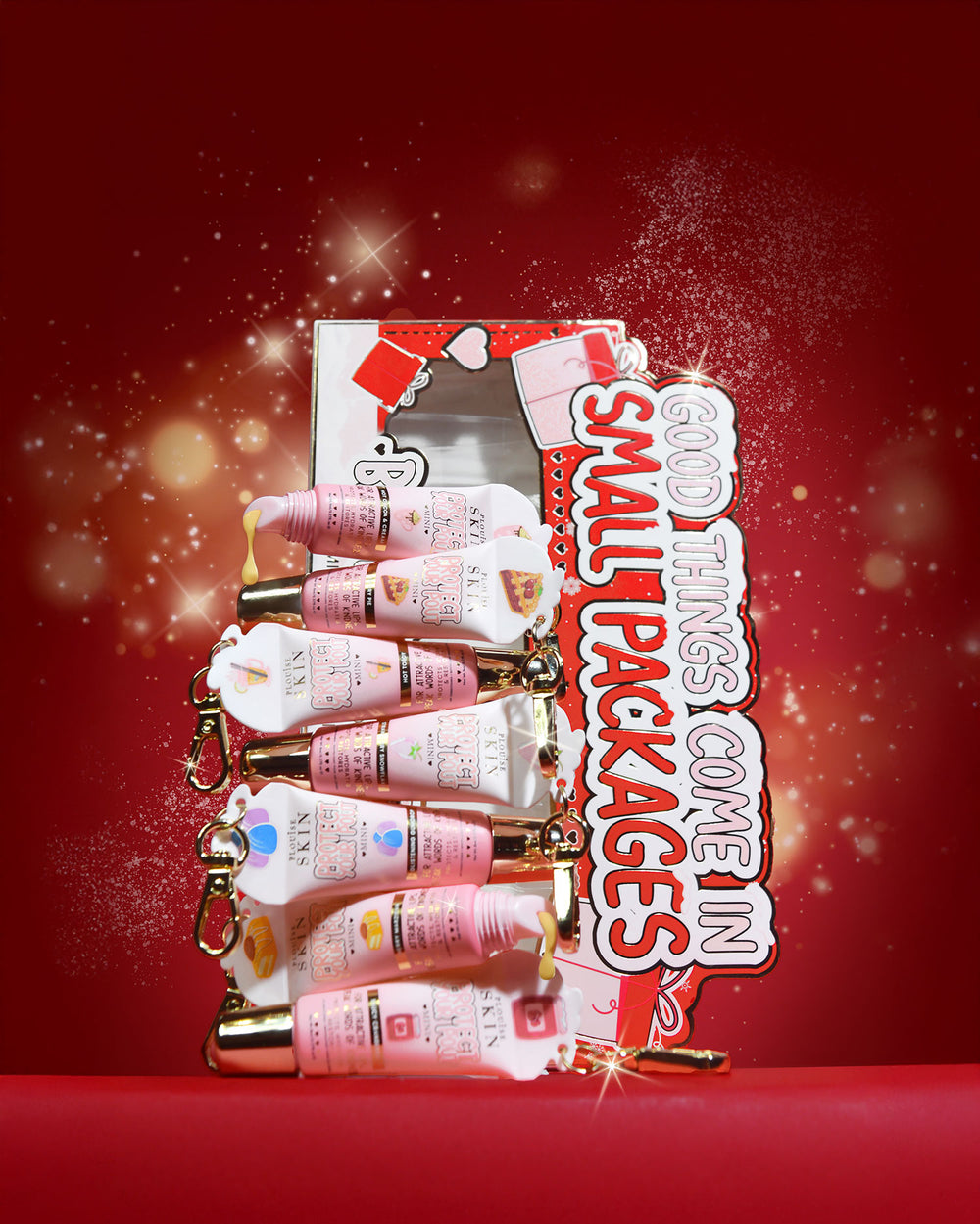 Coffret cadeau de mini revitalisant à lèvres « All Good Things Come In Small Packages » sur fond rouge