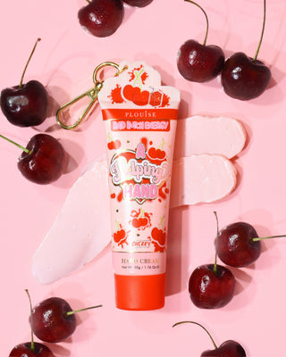 P. Louise A Helping Hand Hand Cream with cherries surrounding it on a pink background
