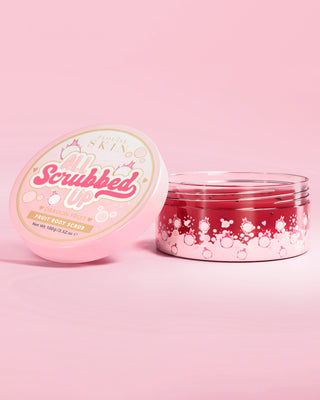 Open jar of P. Louise All Scrubbed Up body scrub in dragon fruit on a pink background