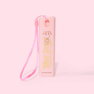 Pink mini keychain travel sized P.Louise thirst seeker hydrating setting spray with a strap on a pink background