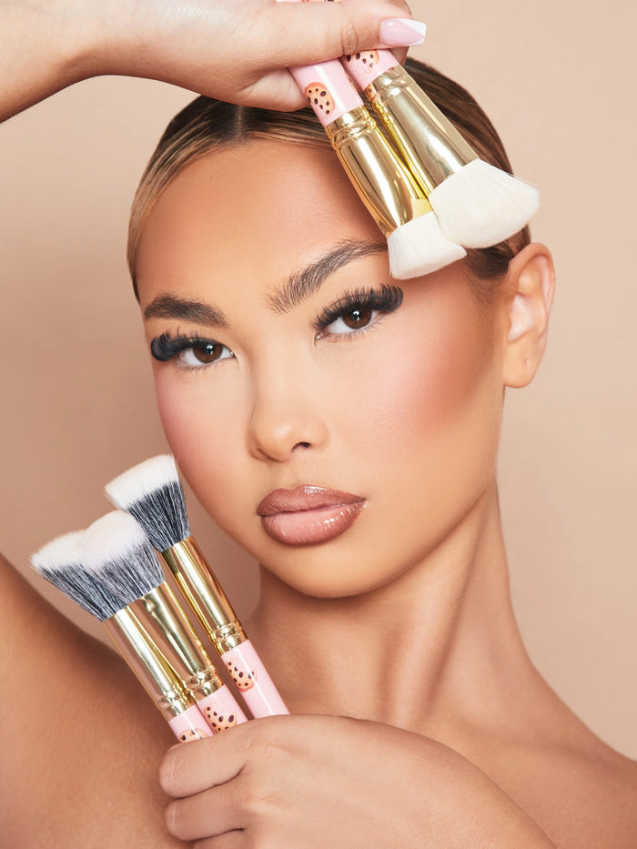 An image of a woman model wearing makeup holding the P.Louise Spoilt For Choice 5-Piece Face Makeup Brush Set against her face