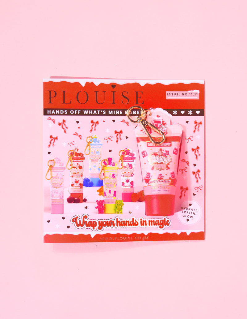 P.Louise kerstmagazine met een mini-sleutelhanger pittige cranberry handcrème bevestigd aan het tijdschrift met een rood en roze feestelijk ontwerp